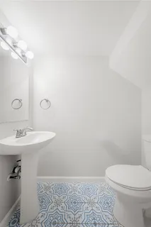a bathroom with a sink a toilet and mirror