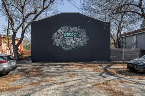 a view of building with car parked