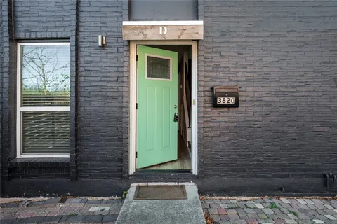 a view of a brick house with a street