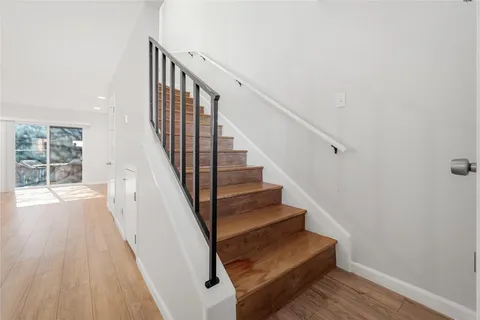 a view of entryway and hall with wooden floor