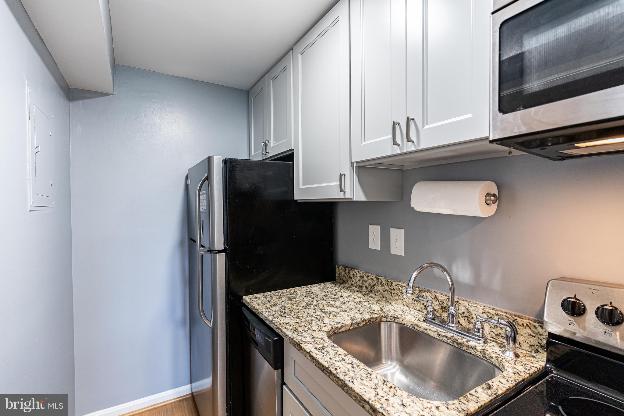 1728 North Rhodes Street, Unit 5275 Arlington, VA 22201 - Photo 6 of 19 Galley kitchen, cabinets to the ceiling