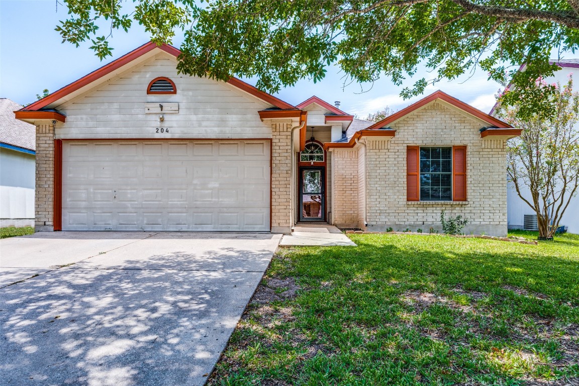 204 Sunshadow Drive Lockhart, TX 78644 - Photo 1 of 1 a front view of a house with a yard and garage
