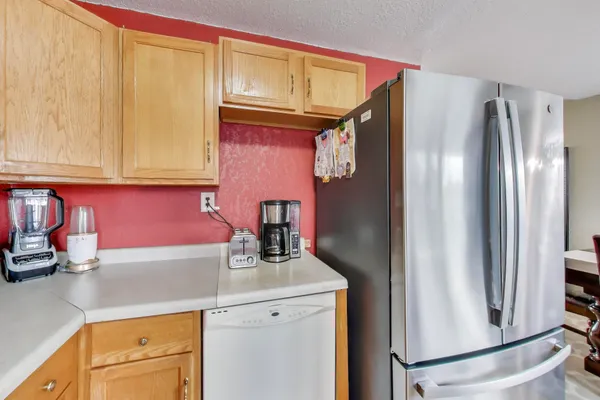 a kitchen with a refrigerator sink and cabinets