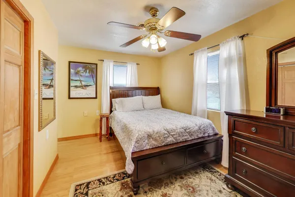 a bedroom with a bed and wooden floor