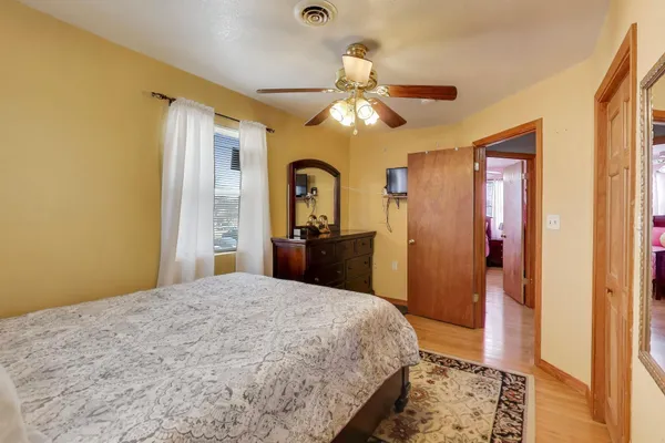 a bedroom with a bed and a chandelier