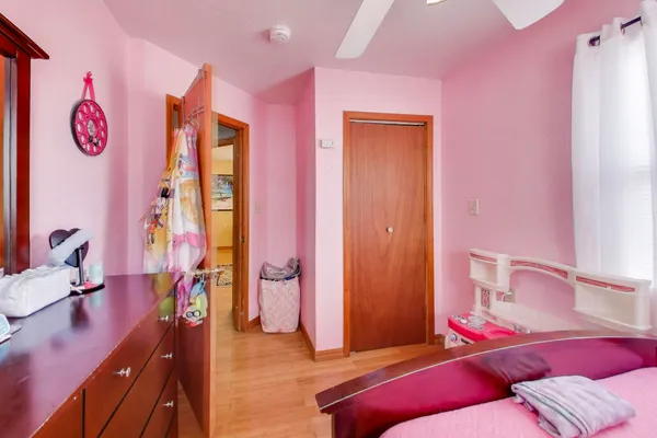 a bedroom with a bed and a lamp