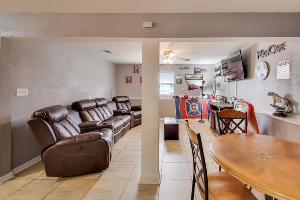 a living room with furniture a air conditioner and a table