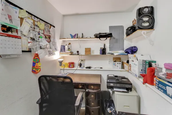a room with a refrigerator and wooden floor