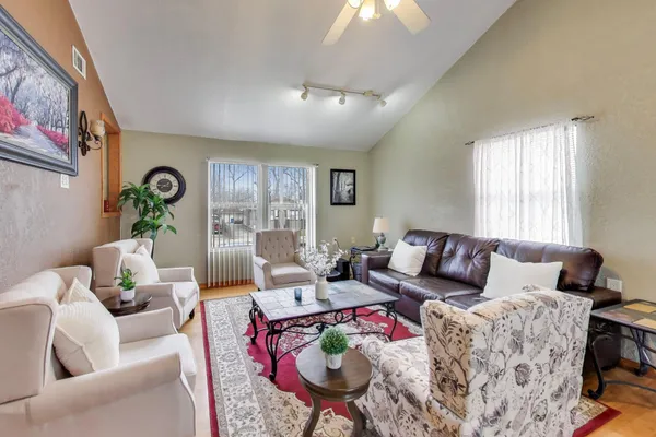 a living room with furniture and wooden floor