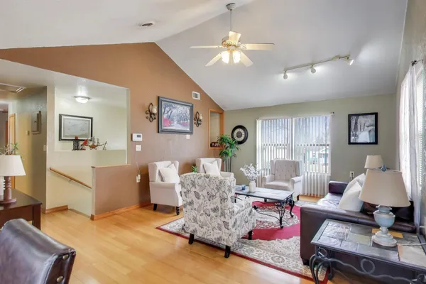 a living room with furniture and a chandelier