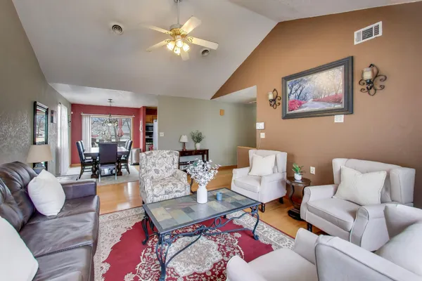 a living room with furniture chandelier and a table