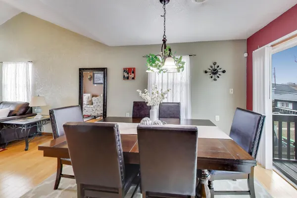 a dining room with furniture potted plants and wooden floor