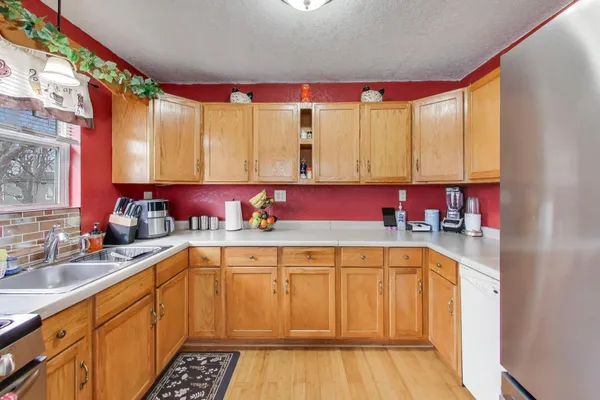 a kitchen with a sink a stove and cabinets