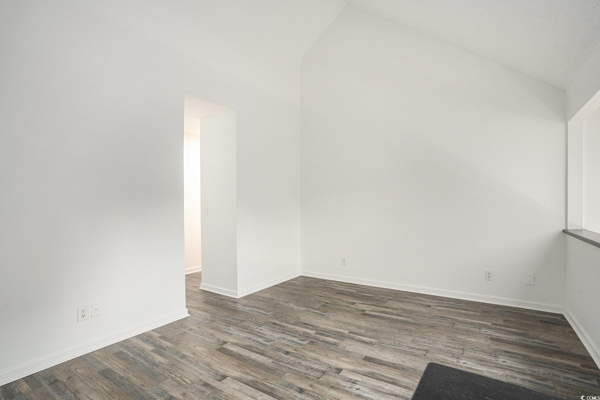 400 Cambridge Circle, Unit L8 Murrells Inlet, SC 29576 - Photo 12 of 22 Additional living space featuring vaulted ceiling and dark wood-type flooring