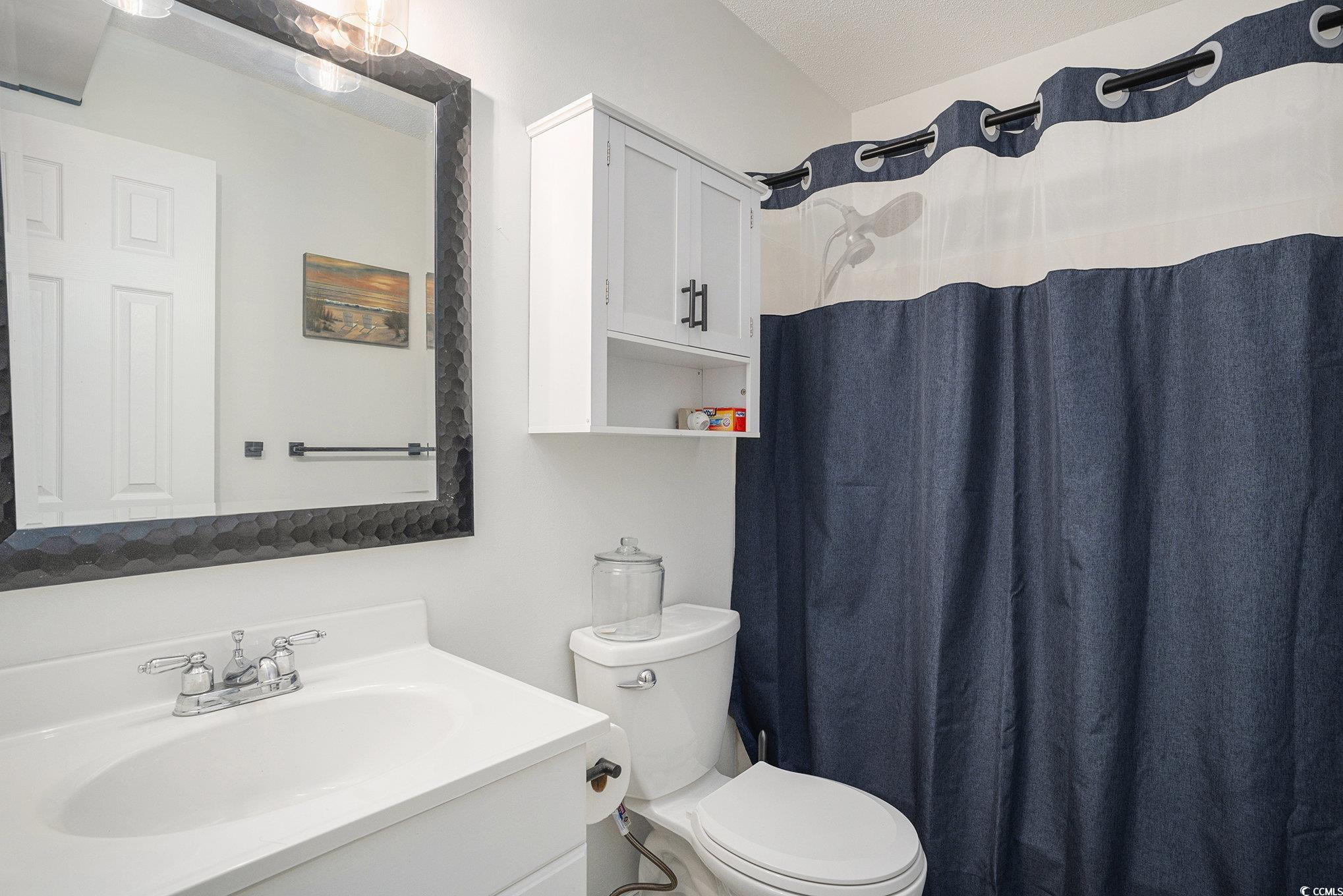 400 Cambridge Circle, Unit L8 Murrells Inlet, SC 29576 - Photo 16 of 22 Bathroom with a shower with shower curtain and vanity