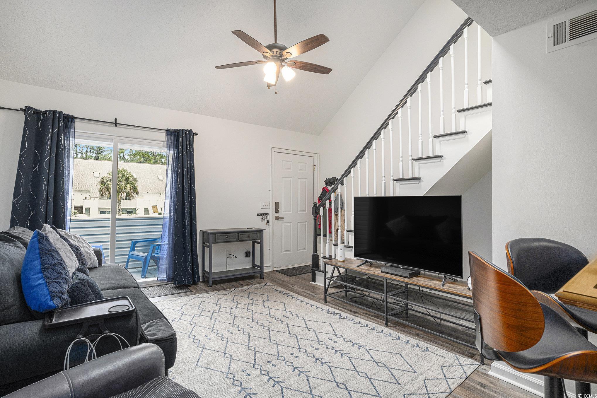 400 Cambridge Circle, Unit L8 Murrells Inlet, SC 29576 - Photo 2 of 22 Living area with light wood-style floors, stairway, a ceiling fan, and high vaulted ceiling