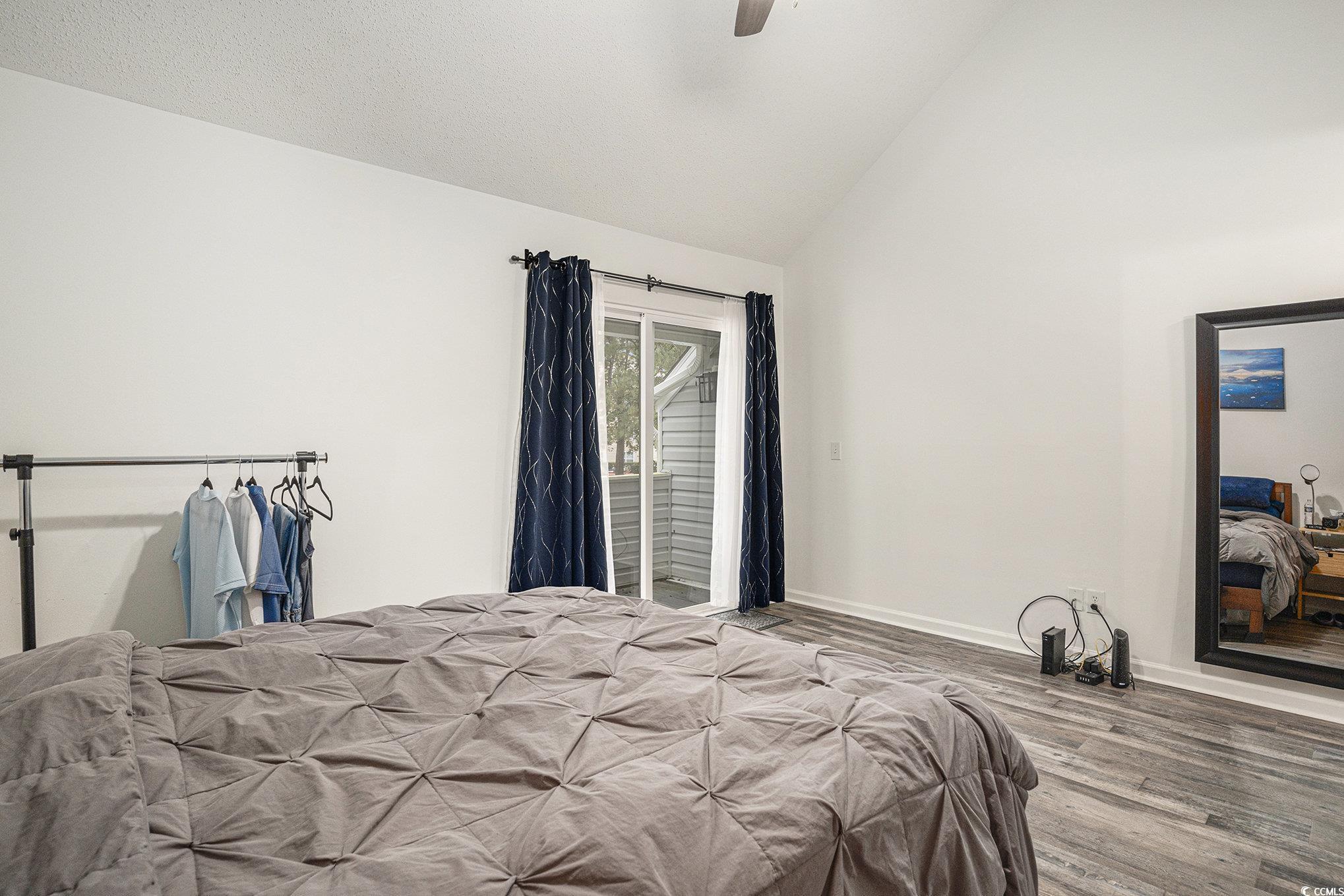 400 Cambridge Circle, Unit L8 Murrells Inlet, SC 29576 - Photo 10 of 22 Bedroom with access to exterior, wood finished floors, ceiling fan, and high vaulted ceiling