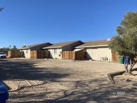 213 South Valley Street Ridgecrest, CA 93555 - Photo 1 of 8 a house view with a wooden fence