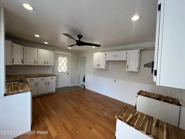 a kitchen with stainless steel appliances granite countertop a sink a stove and a refrigerator