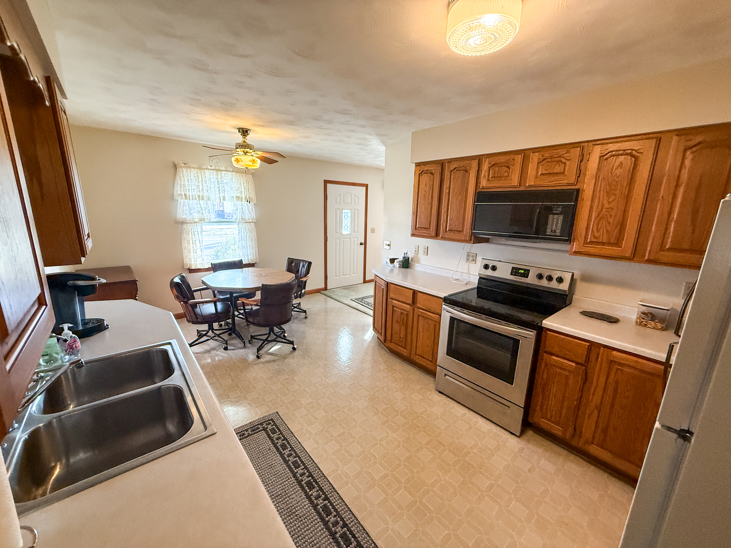218 South 3rd Street Southwest Clay City, IL 62824 - Photo 12 of 63 a kitchen with sink a microwave and furniture