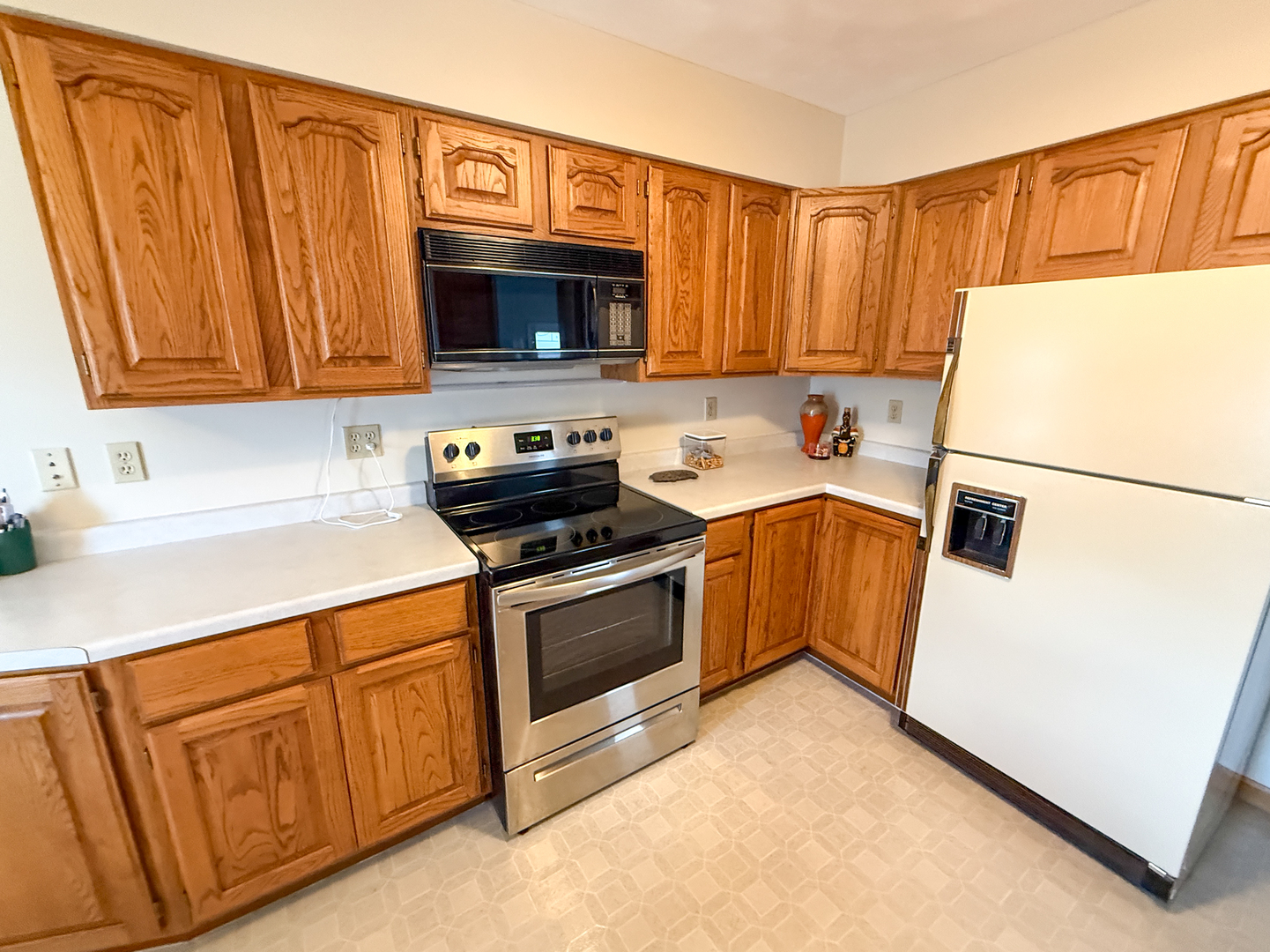 218 South 3rd Street Southwest Clay City, IL 62824 - Photo 14 of 63 a kitchen with stainless steel appliances granite countertop a sink a stove a microwave and a refrigerator