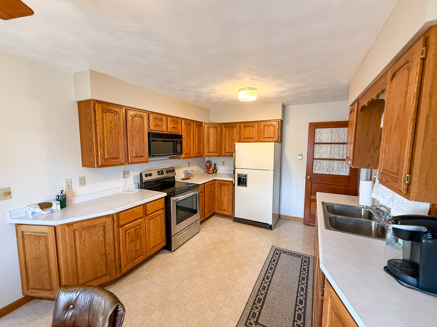 218 South 3rd Street Southwest Clay City, IL 62824 - Photo 15 of 63 a kitchen with stainless steel appliances granite countertop wooden cabinets a stove top oven a granite counter space and a sink
