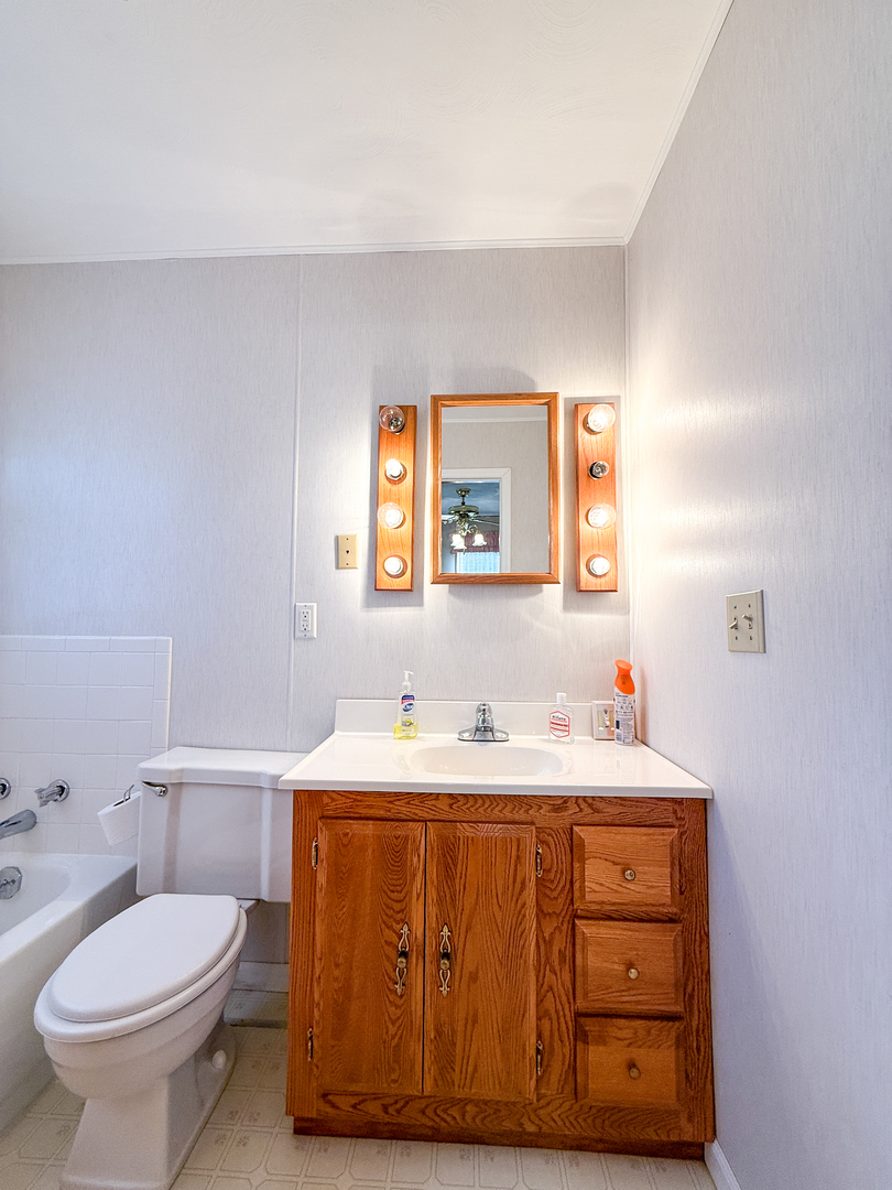 218 South 3rd Street Southwest Clay City, IL 62824 - Photo 25 of 63 a bathroom with a sink toilet and mirror