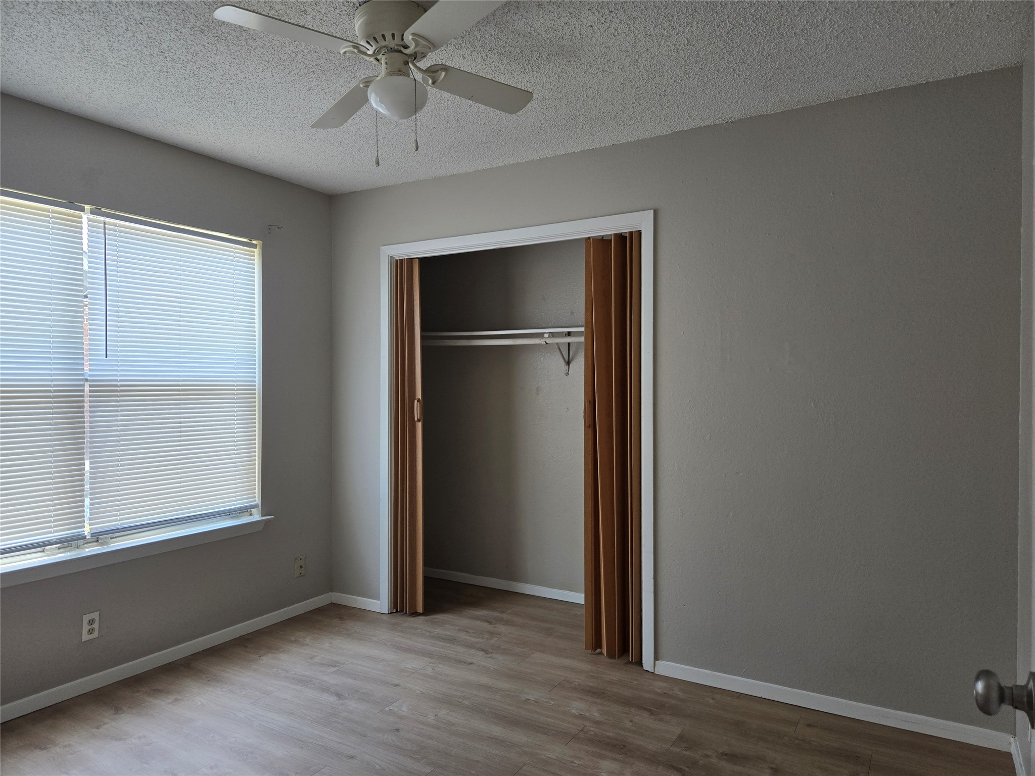 1011 Ridgemont Street Round Rock, TX 78664 - Photo 7 of 14 an empty room with wooden floor closet and windows