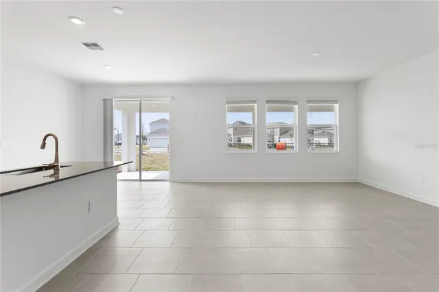 a kitchen with granite countertop a sink and cabinets