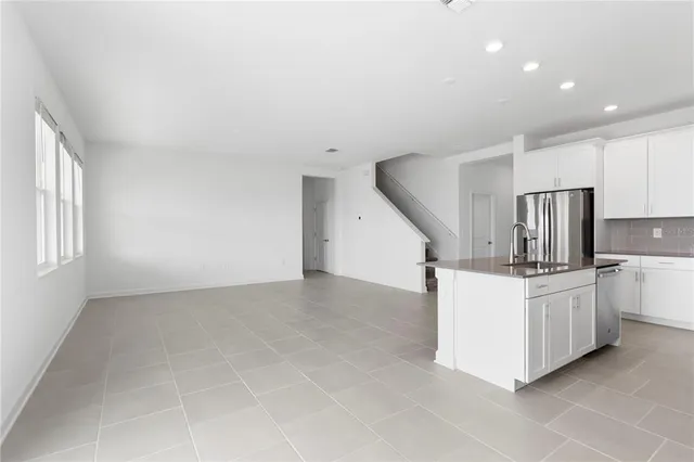 a kitchen with stainless steel appliances a refrigerator a stove a sink a microwave and cabinets