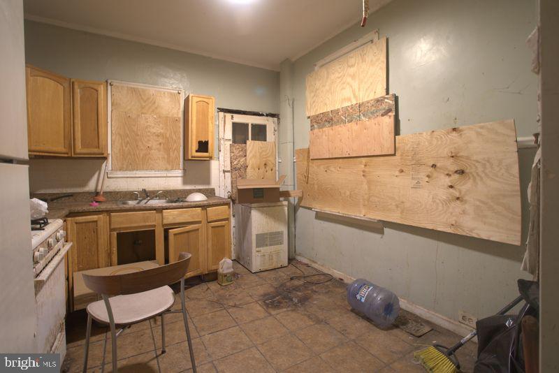 2140 South Simpson Street Philadelphia, PA 19142 - Photo 4 of 12 a kitchen with a refrigerator and a stove