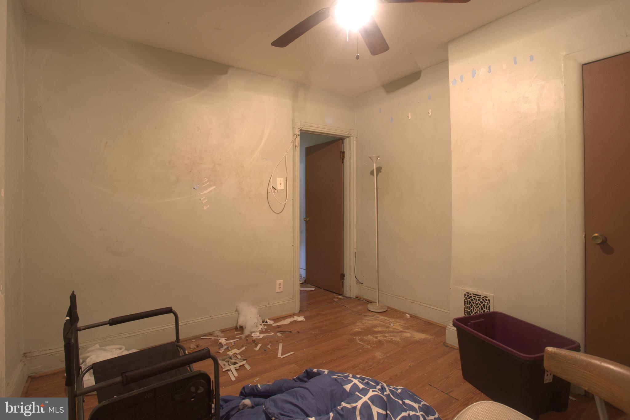 2140 South Simpson Street Philadelphia, PA 19142 - Photo 7 of 12 a bedroom with a bed and a mirror