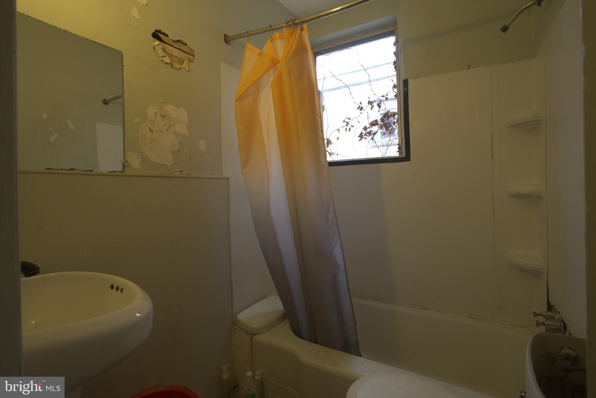 2140 South Simpson Street Philadelphia, PA 19142 - Photo 8 of 12 a bathroom with a shower and a toilet