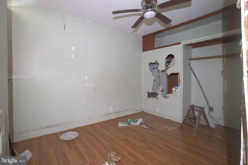 2140 South Simpson Street Philadelphia, PA 19142 - Photo 9 of 12 a view of a room with wooden floor and ceiling fan