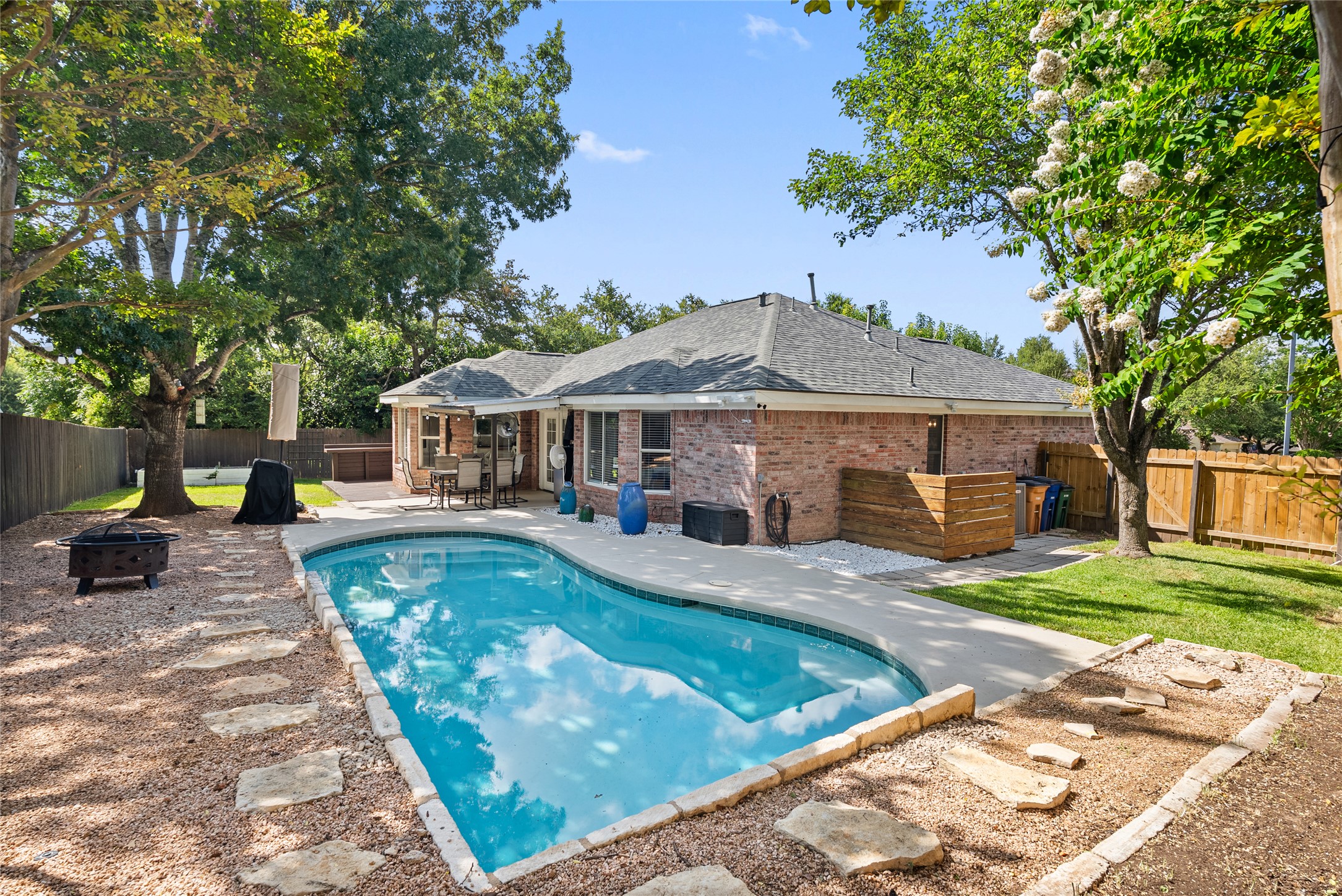 Shaded by mature trees, the pool area feels entirely private, making evening swims a quiet, peaceful routine.