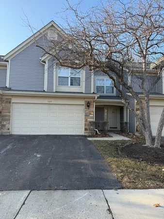 a view of a house with a yard and sitting area