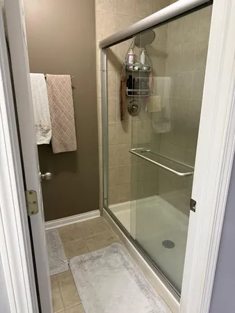 a bathroom with a glass shower door