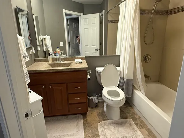 a bathroom with a sink toilet and shower