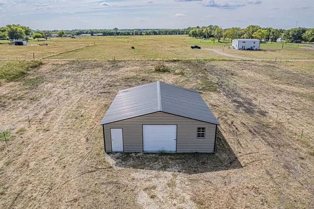 a house view with a outdoor space and lake view