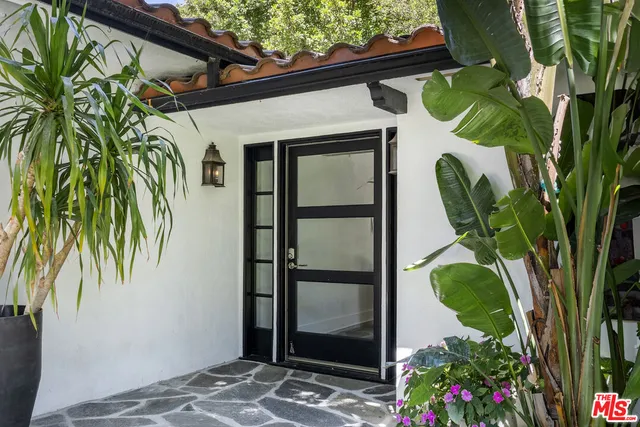 a kitchen with a wooden floor and chairs