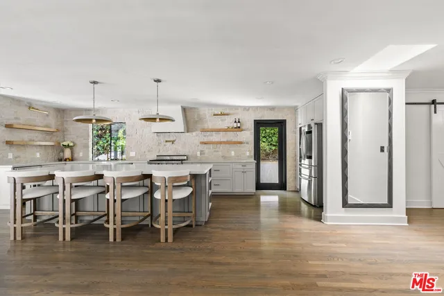a kitchen with stainless steel appliances granite countertop a stove and cabinets