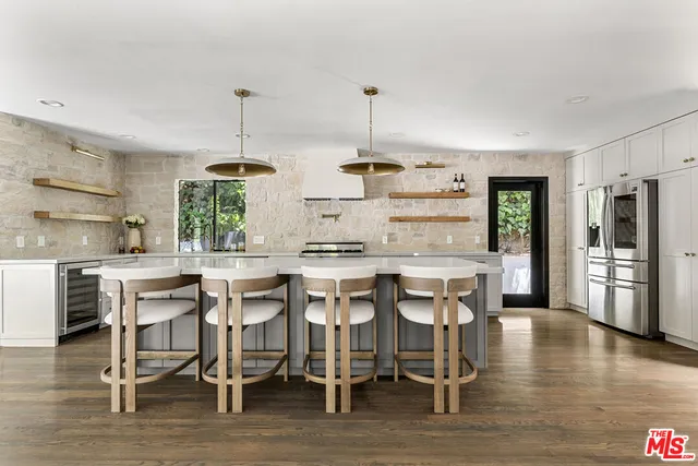 a stove top oven sitting inside of a kitchen