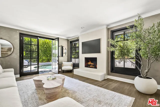 a dining room with furniture a chandelier and wooden floor