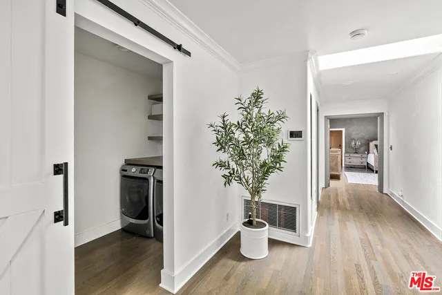 a bedroom with a bed and a refrigerator