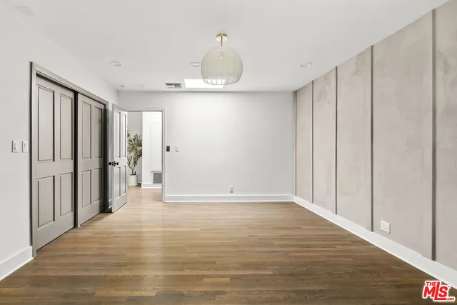 a view of an entryway with a floor to ceiling window and wooden floor