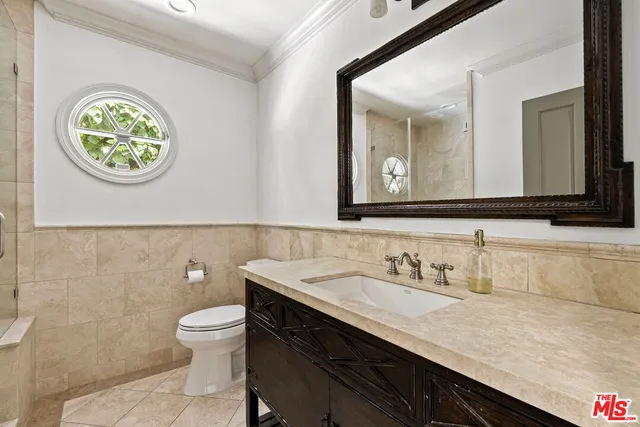 a bathroom with a double vanity sink a mirror and a bathtub