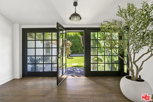 a living room with furniture rug and a large window