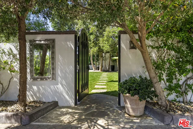 a view of a porch with plants and trees