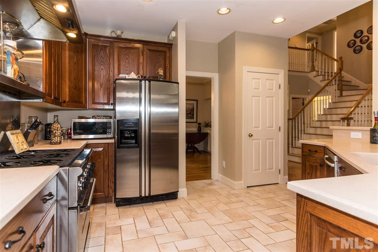 6521 Arbor Grande Way Raleigh, NC 27615 - Photo 4 of 12 a kitchen with granite countertop a refrigerator and a sink