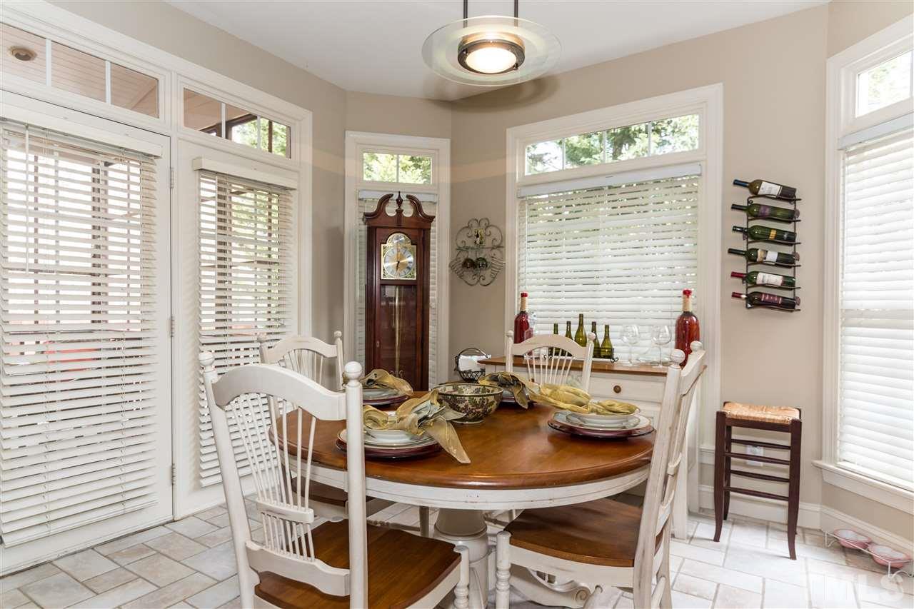 6521 Arbor Grande Way Raleigh, NC 27615 - Photo 9 of 12 a view of a dining room with furniture and windows